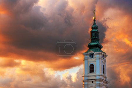 Téléchargez les photos : Tour de l'église de la Dormition à Novi Sad, Serbie. Bel édifice religieux orthodoxe au coucher du soleil d'été. Concentration sélective. - en image libre de droit
