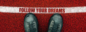 Follow your dreams text on rubber playground flooring, male boots from above standing next to the line, directly above Sweatshirt #710846982