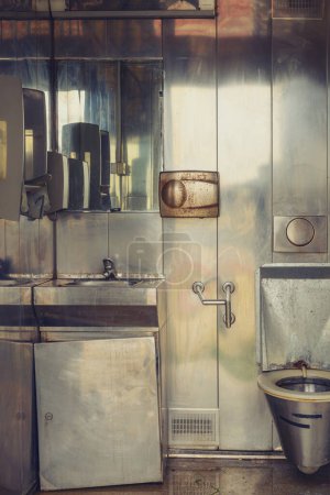 Photo for Old dirty public toilet with metallic interior, vertical image - Royalty Free Image