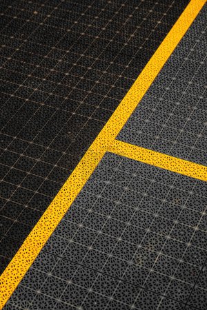Gelbe Markierungslinien, Spielfeldrand auf rutschfestem Kunststoffboden des Outdoor-Basketballfeldes, selektiver Fokus