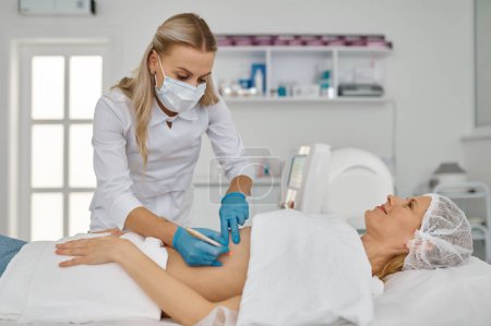 Nahaufnahme Elektroepilation kosmetische Verfahren zur Haarentfernung aus dem Bauch der Frau. Medizinische Versorgung
