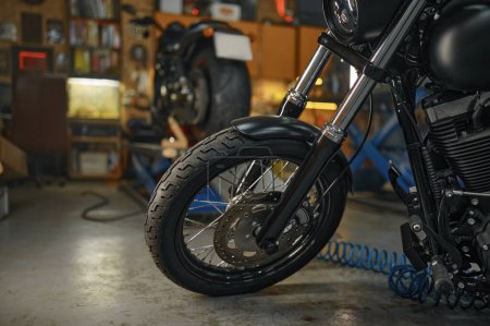 Photo for Selective focus on motorcycle front wheel. Maintenance and repair motorbike in garage concept - Royalty Free Image