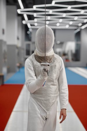Photo for Sword sport athlete portrait wearing protective clothes and helmet at training. Fencer traditional greeting. Professional fencing tournament - Royalty Free Image