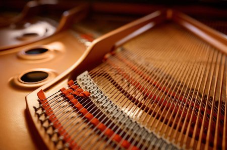 Photo for Selective focus with closeup view on hammers and strings inside grand piano. Musical keyboard instrument at shop store - Royalty Free Image