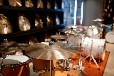 Photo for Selective view on drum set and several golden cymbal plates in music shop. Musical instrument assortment in art store - Royalty Free Image