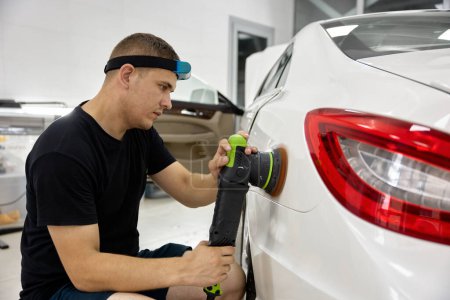 Photo for Car service worker applying special nano-ceramic polish cream for car painting coat refreshment. Auto detailing service - Royalty Free Image