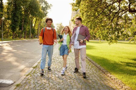 Photo for Casual diverse students chatting while walking and hanging out together during university campus break - Royalty Free Image