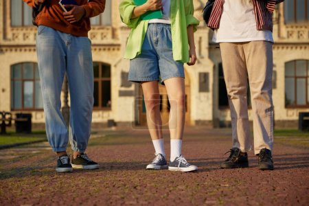 Photo for Group of smart students standing outdoors at campus. High school university youth community. Crop shot - Royalty Free Image