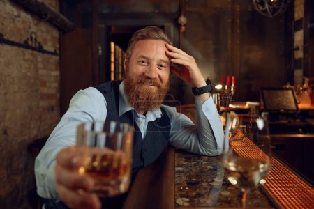 Photo for Portrait of happy smiling drunk man clinking with glass to camera. Businessman enjoying free time having fun drinking alcohol after work - Royalty Free Image