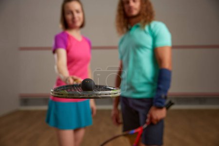 Photo for Happy couple posing for camera after squash game. Motivation and effort training concept - Royalty Free Image