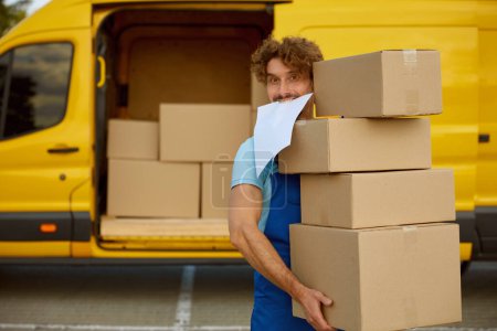 Photo for Funny deliveryman carrying pile of cardboard boxes and checklist documents in mouth. Professional shipping service, fast online order delivery - Royalty Free Image