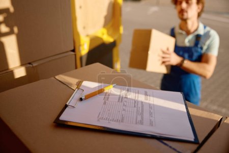 Photo for Closeup delivery document or application form for package receiving by customer. Freight transportation and parcel delivery service - Royalty Free Image