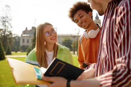 Photo for Group of cheerful students sharing good news while discussing exam results. Overjoyed multicultural friends enjoying outdoor meeting after university classes - Royalty Free Image