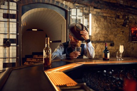 Photo for Handsome rich well-dressed gentleman rest drinking alcoholic beverage in pub - Royalty Free Image