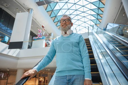 Photo for Happy fashion elderly man with purchases in shopping mall - Royalty Free Image