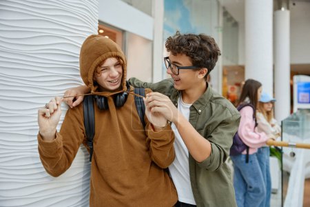 Photo for Two funny teen boys fooling around having good time in mall. Relax time on weekend, shopping tour enjoyment - Royalty Free Image