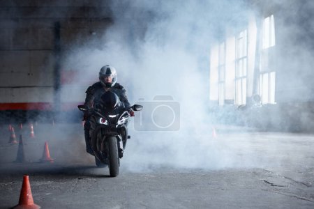 Photo for Motorcyclist riding fast at training motordrome of driving school. High speed extreme driving class - Royalty Free Image