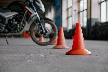 Photo for Training motorcycle between traffic road cone at driving school motordrome. Professional education class for motorbike drivers - Royalty Free Image