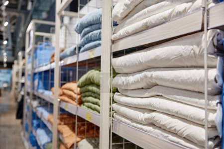 Photo for Shopping showcase rack with folded textile bedding items assortment with price sales tags. Modern linen shop store market offering linen with discount - Royalty Free Image