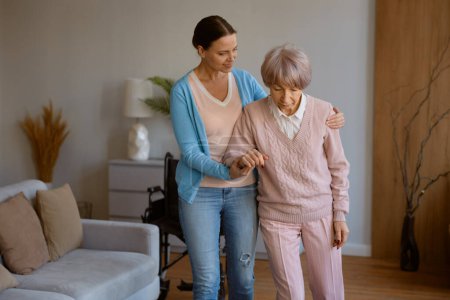 Photo for Young daughter caring for retired mom with physical or mental disorder. Woman helping elderly mother in recovery sharing love and support - Royalty Free Image