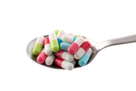 Téléchargez les photos : Colorful pills on spoon isolated on white background with clipping path - en image libre de droit