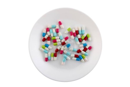 Téléchargez les photos : Colorful pills on a plate isolated on white background with clipping path - en image libre de droit