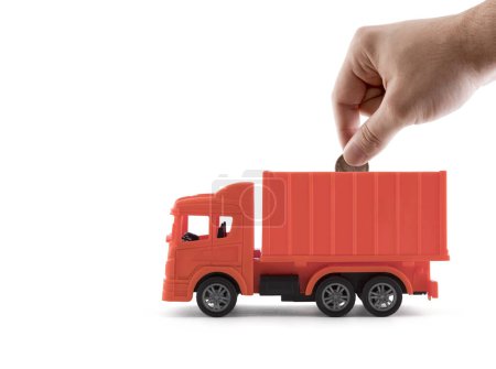 Photo for Putting coin into the red cargo delivery truck on white background - Royalty Free Image