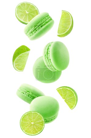 Foto de Macaroons and pieces of lime fruit levitation isolated on white background - Imagen libre de derechos