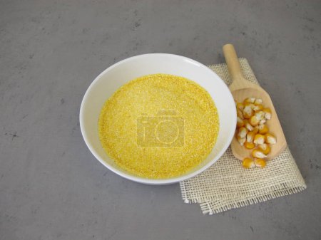 Photo for Corn semolina in a shallow bowl and maize kernels - Royalty Free Image