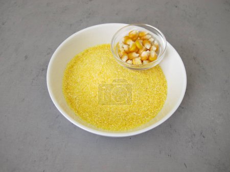 Photo for Corn semolina in a shallow bowl and maize kernels - Royalty Free Image
