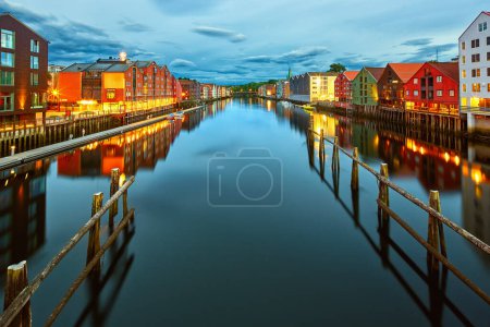 Photo for Colorful timber houses over river Nidelva at dusk in Trondheim, Norway - Royalty Free Image
