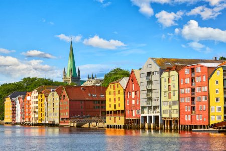 Photo for Old wooden houses  and Nidaros cathedral over Nidelva river in Trondheim, Norway - Royalty Free Image