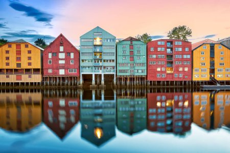 Photo for Colorful old houses over the Nidelva river at summer sunset in Trondheim, Norway - Royalty Free Image