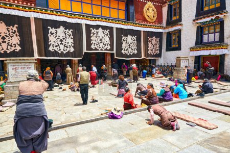 Photo for Lhasa, Tibet - May 12, 2014: Pilgrims prayer from all over Tibet and prostration in front of the Jokhang temple. - Royalty Free Image