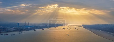 Photo for Panoramic view of the crepuscular rays over the Yangtze River, Jiujiang city, Jiangxi province, China - Royalty Free Image