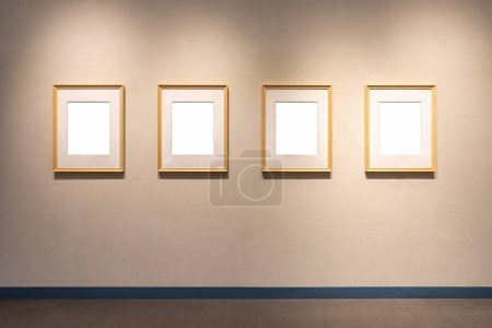 Photo for Four blank wooden picture frames on exhibition wall, clipping path includes - Royalty Free Image