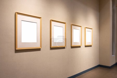 Photo for Four blank wooden picture frames with clipping path on exhibition wall - Royalty Free Image