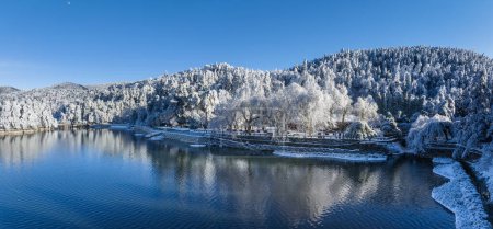 pure natural scenery of Mount Lu in winter, lake and rime trees against a blue sky, Lushan mountain national scenic area, China