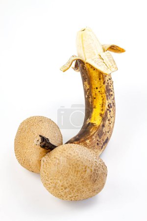 Ripe banana with brown spots on a white background.