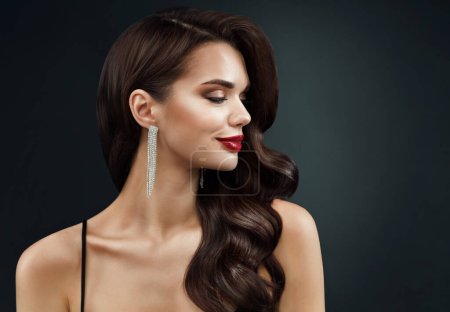 Photo for Beauty Model Face Profile with Red Full Lips Make up. Beautiful Woman Side view Curly Waves Hairstyle and Silver Earring over dark Background. Women Holiday Makeup - Royalty Free Image
