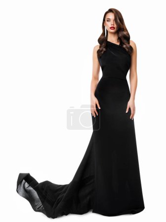 Photo for Fashion Woman in Black Long Dress. Beautiful Model in Evening Gown with Train over White Background. Elegant Lady with Holiday Wavy Hair style and Glamour Makeup - Royalty Free Image