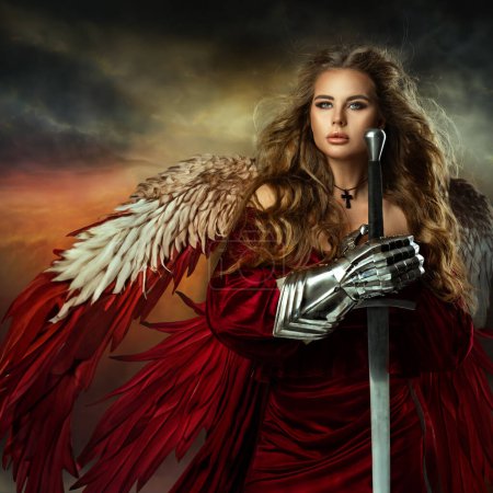 Photo for Warrior Woman with Sword. Medieval Female Knight in Armor. Beautiful Viking Girl as Battle Goddess with Wings in Red Fantasy Dress over Sky Background - Royalty Free Image