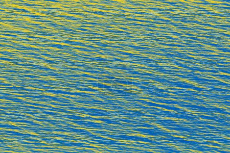 Téléchargez les photos : Abstract background: water surface of  sea colored in colors of Ukrainian flag - en image libre de droit