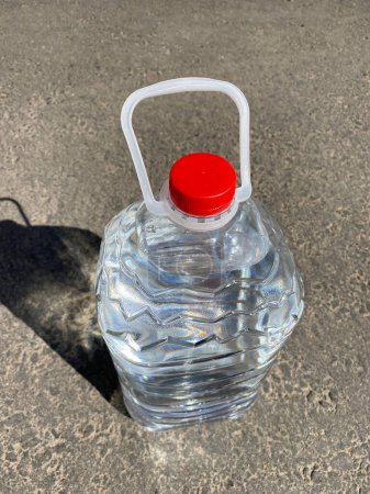 Photo for Plastic bottle of water standing on road - Royalty Free Image