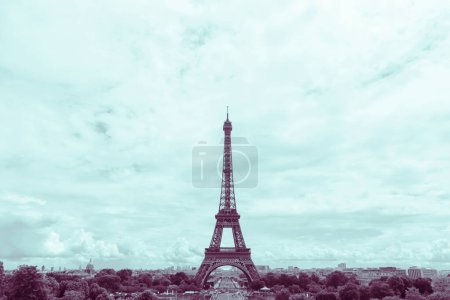 Photo for Sight of Eiffel Tower in Paris at summer toned in aqua and purple - Royalty Free Image