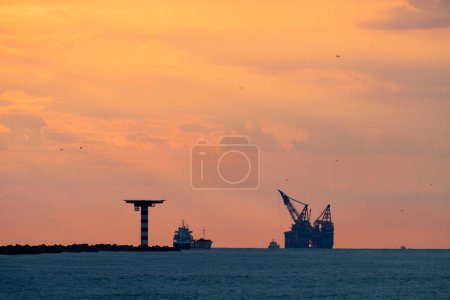 Oil rig in sunset at sea