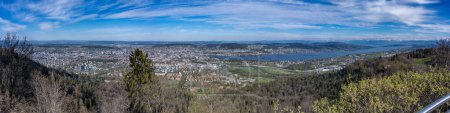 Panoramic view of Zurich lake and Alps from the top of Uetliberg mountain, from the observation platform on tower on Mt. Uetliberg, Switzerland, Europe