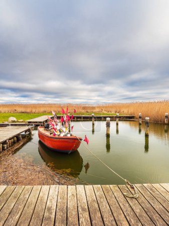 Photo for Red fishing boat in the port of Althagen, Germany. - Royalty Free Image