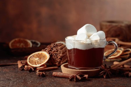 Photo for Hot chocolate with marshmallows. Winter drink with spices on a dark brown background. - Royalty Free Image
