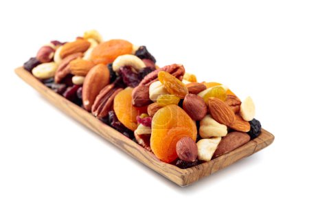 Photo for Mix of nuts and dried fruits isolated on a white background. Presented apricots, raisins, walnuts, hazelnuts, cashews, pecans, and almonds. - Royalty Free Image